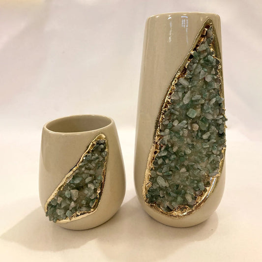 Two ceramic vases with green stone inlay on a white background
