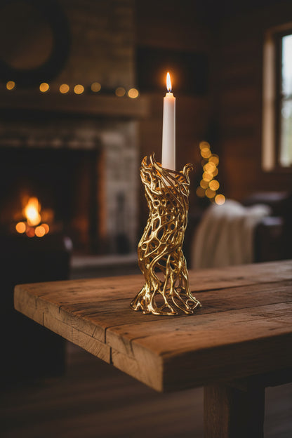Gold candle holder with a white candle on a white background